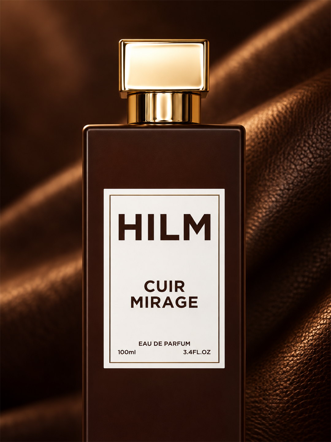 Hilm Cuir Mirage Eau de Parfum bottle, 100ml, featuring a dark brown rectangular glass bottle with a white label and a gold cap, set against a draped brown leather background.